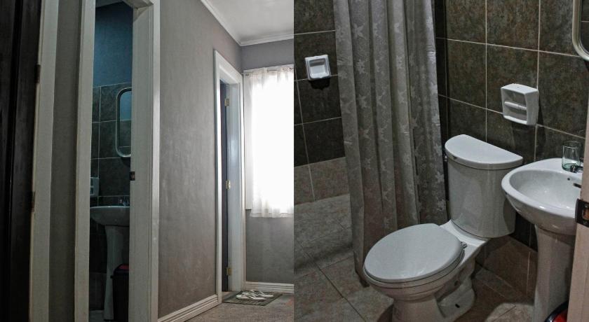 a bathroom with a toilet a sink and a mirror, RB Bed and Breakfast in Kalibo