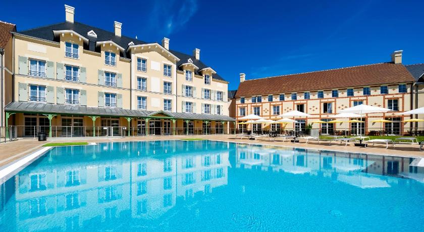 a hotel room with a pool and a large building, Staycity Aparthotels near Disneyland Paris in Paris