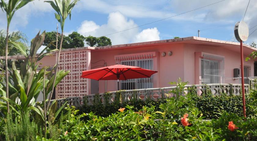 a red and white house with a red umbrella, Old American House K-113 in Okinawa Main island