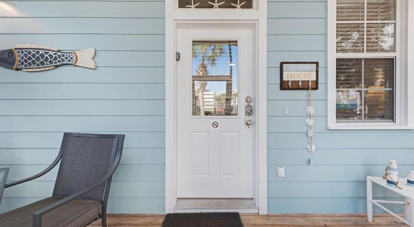 a room with a blue door and a blue chair, Barefoot Cottages #B32 in Port Saint Joe