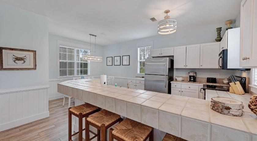 a kitchen with a stove top oven and a sink, Barefoot Cottages #B32 in Port Saint Joe
