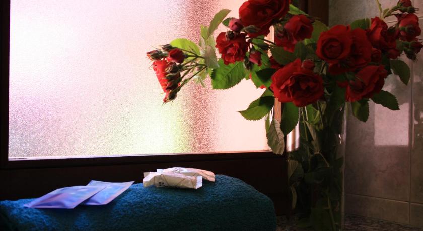 a vase of flowers sitting on a table next to a window, La Corte Albergo in Desio