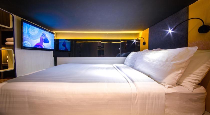 a bed with a white comforter on top of it, CUBE Family Boutique Capsule Hotel @ Chinatown (SG Clean Certified) in Singapore