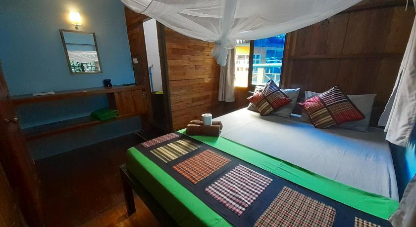 a bedroom with a bed and a canopy, Bong's Guesthouse M'Pai Bay in Koh Rong Sanloem