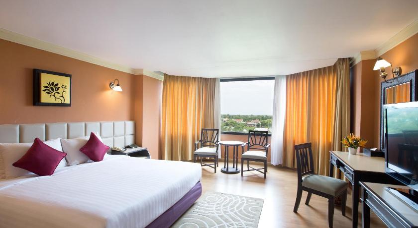 a hotel room with two beds and a television, The Imperial Hotel and Convention Centre Phitsanulok (SHA Extra Plus) in Phitsanulok