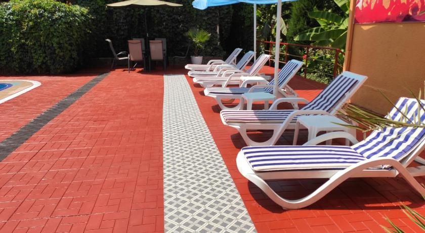 a patio area with chairs, tables, umbrellas and umbrellas, Asia Hotel Fergana in Fergana