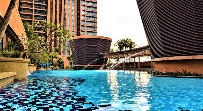 a swimming pool filled with lots of blue water, The Apartments @ Times Square in Kuala Lumpur