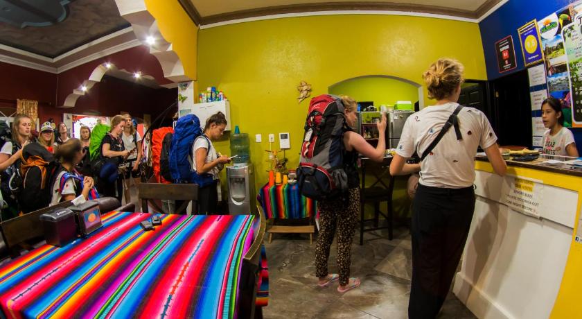 people standing around a counter in a store, Hostal Casa de Grethel in Flores