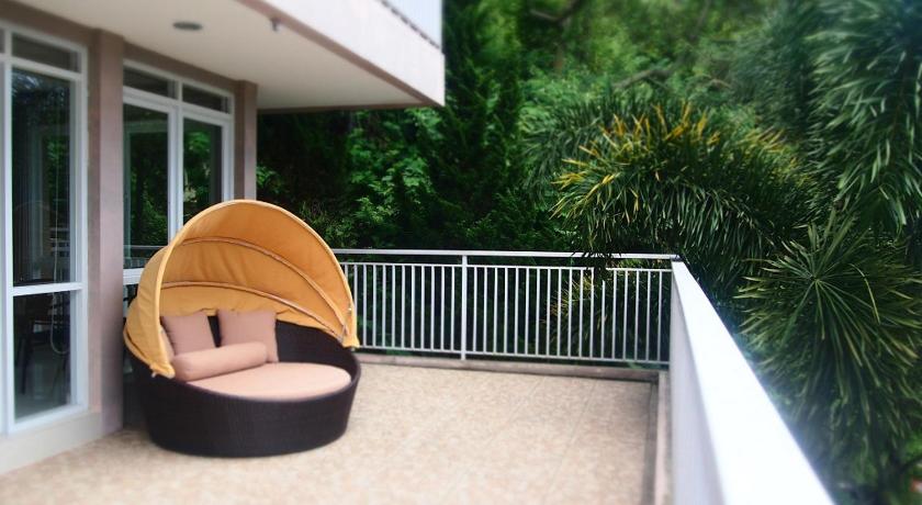 a small umbrella sitting on top of a patio, Villa D14 in Bandung