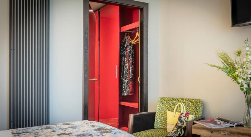 a bedroom with a red door and a red bed, Boyne Valley Hotel - Bed & Breakfast Only in Drogheda