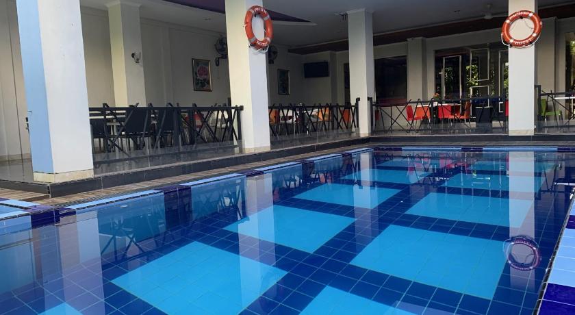 a swimming pool with a pool table and chairs, Pacific Hotel Ambon in Ambon