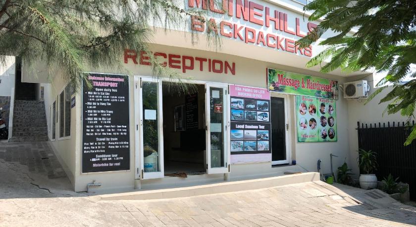 a store front with a neon sign on the front of it, Mui Ne Hills Backpackers in Phan Thiet