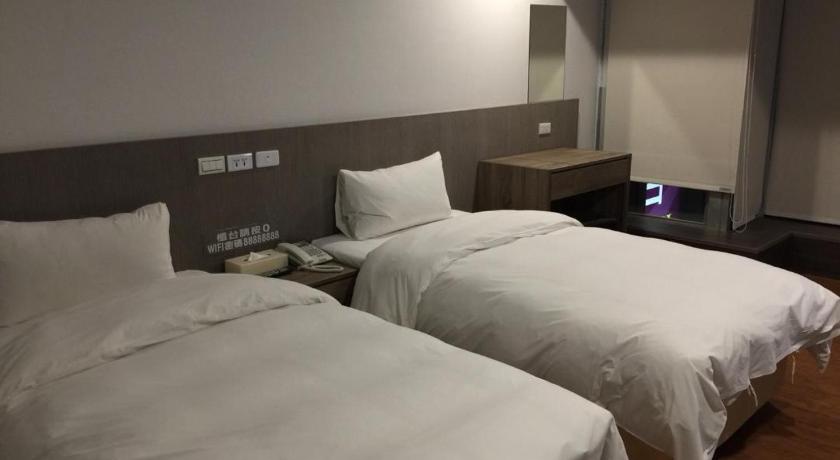 a hotel room with two beds and two nightstands, WISH HOTEL in Taoyuan