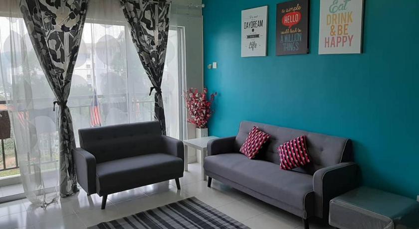 a living room filled with furniture and a blue couch, Homestay Puncak Alam Residensi Allamanda in Klang
