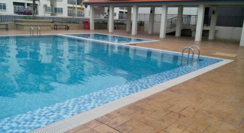 a swimming pool with a pool table and chairs, Homestay Puncak Alam Residensi Allamanda in Klang