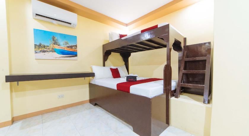 a hotel room with a bed and a tv, RedDoorz near Notre Dame of Dadiangas University - Vaccinated Staff in General Santos City