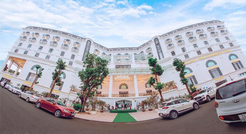 a large building with cars parked in front of it, Duc Huy Grand Hotel and Spa in Lao Cai City