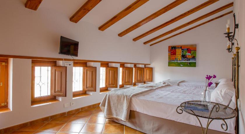 a room with a bed, a table, and a window, Hotel Jaime I in Mora de Rubielos