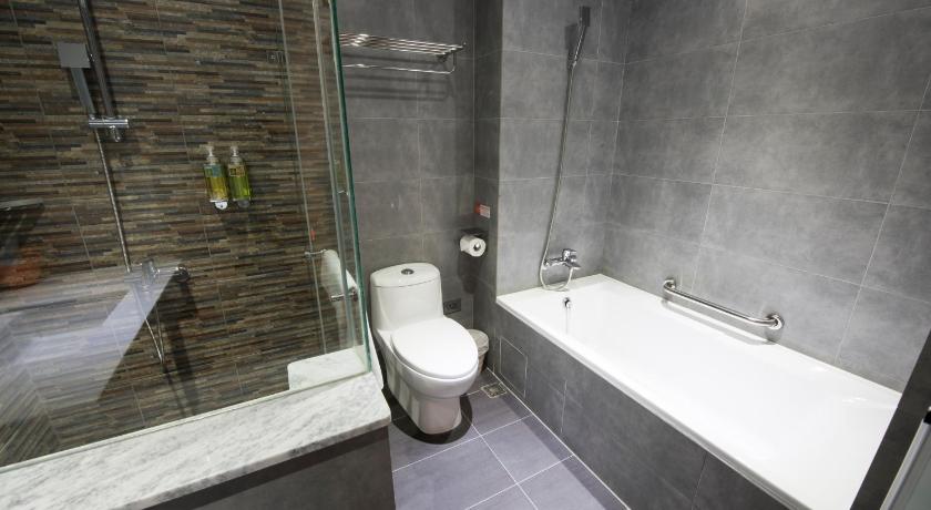 a bathroom with a tub, toilet and sink, Legend Hotel Pier 2 in Kaohsiung