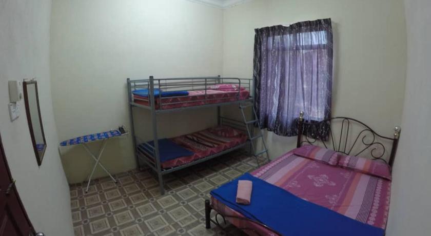 a bed room with two beds and a window, Homestay Tok Abah Kuala Besut in Besut