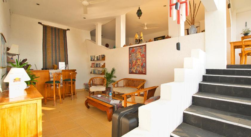 a living room filled with furniture and a staircase, Sunset Lavinia Hotel in Lombok