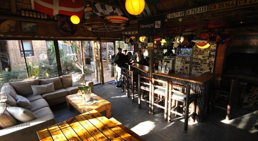 a restaurant with tables, chairs, and tables in it, Saltycrax Backpackers in Cape Town