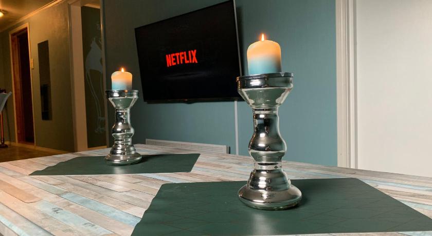 a candle is lit on a table in front of a television, Beautiful apartment in central Leknes in Leknes