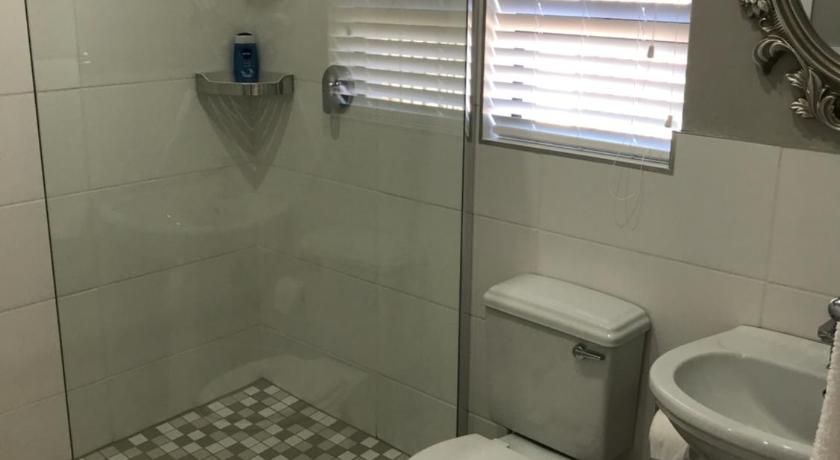 a bathroom with a toilet, sink, and shower stall, Steenkoppies estate semi self catering unit 1 in Magaliesburg