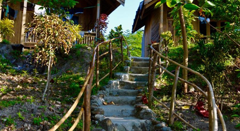 a walkway leading up to a stone wall, Pristine Paradise Dive Resort Una Una in Pulau Una Una