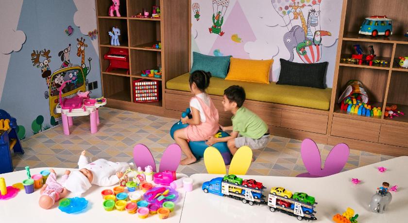 a boy and a girl playing with toys on a table, Holiday Inn & Suites Saigon Airport in Ho Chi Minh City