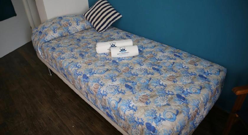 a bed with a blue blanket on top of it, House SottoCoperta in Civitavecchia