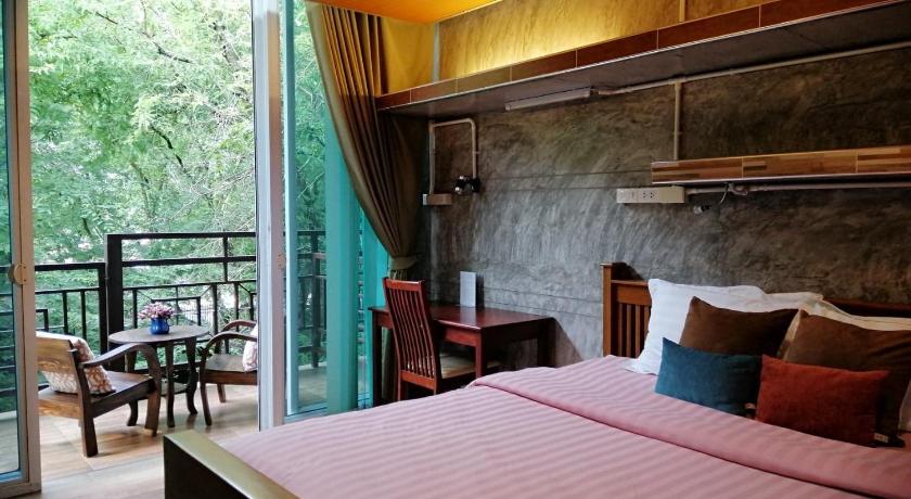 a bedroom with a bed and a chair, Loei Huen Hao Hug Home & Resort in Loei