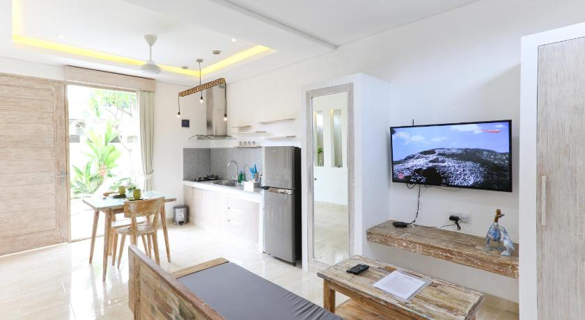 a living room with a tv and a kitchen, Green Studio Apartment in Bali