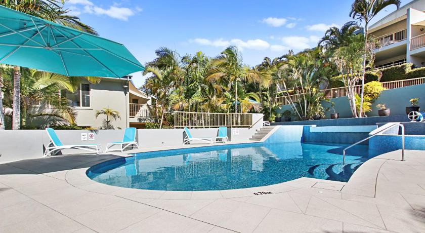 a swimming pool with a pool table and chairs, Lennox Beach Resort in Lennox Head