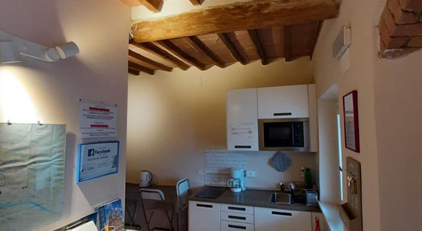a kitchen with a stove top oven and a microwave, Smile Tower House in Pisa