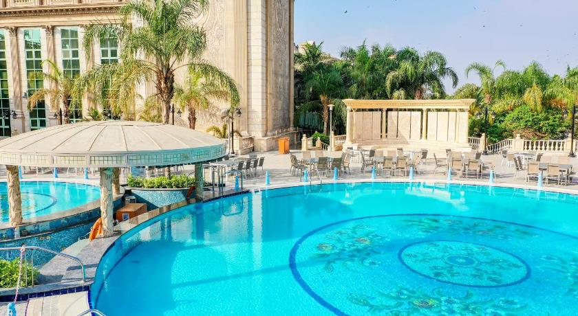 a swimming pool with a large blue umbrella, Al Masa Hotel Nasr City in Cairo