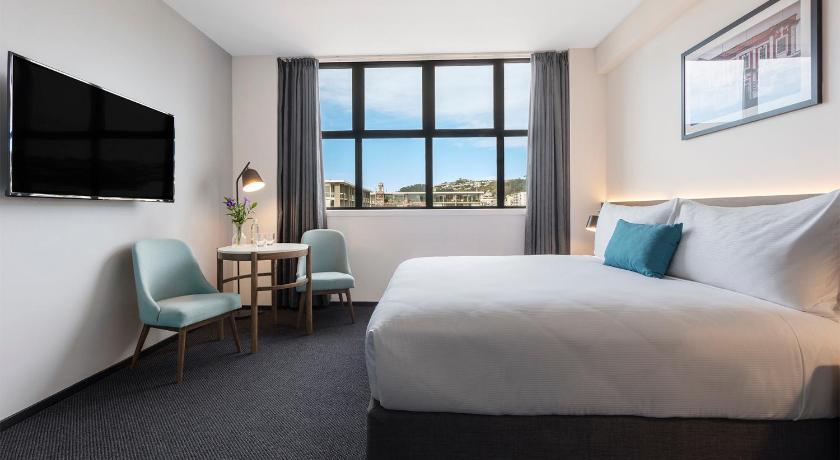 a hotel room with two beds and a television, Oaks Wellington Hotel in Wellington