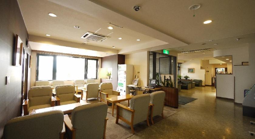 a living room filled with furniture and a large window, Hotel Route Inn Iida in Iida