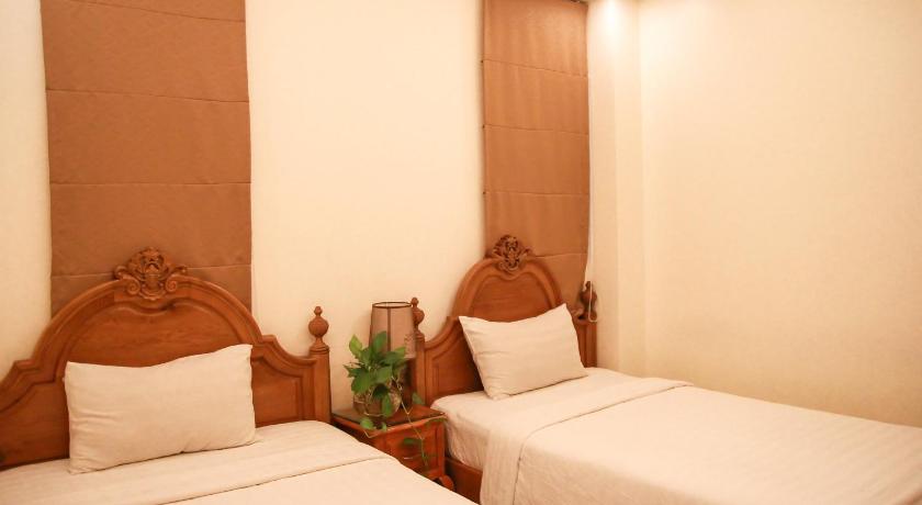 a hotel room with two beds and two lamps, Erato Boutique Hotel in Ho Chi Minh City