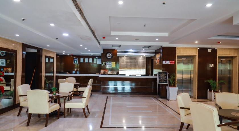 a large kitchen with a lot of tables and chairs, Airport Residency in New Delhi and NCR