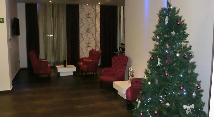 a living room filled with christmas trees and a christmas tree, California Hotel Barcelona in Barcelona