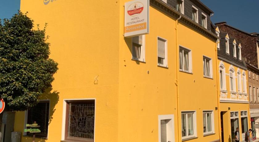 a yellow building with a sign on the side of it, Hotel Sonnenhof in Boppard