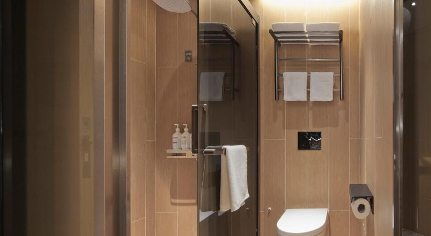 a bathroom with a toilet, sink, and shower, Ji Hotel Orchard Singapore in Singapore