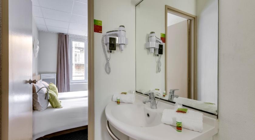 a bathroom with a sink and a mirror, Hotel Chagnot in Lille