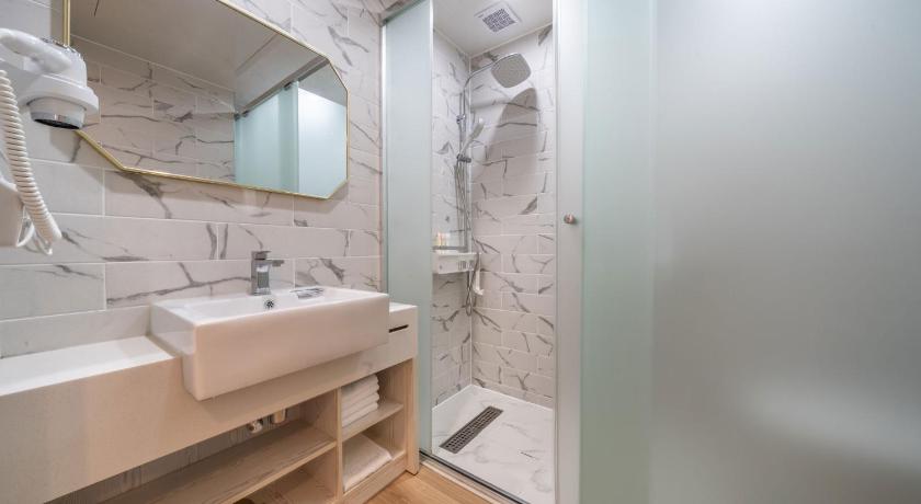 a bathroom with a sink and a mirror, Aroomi Hotel in Jeju