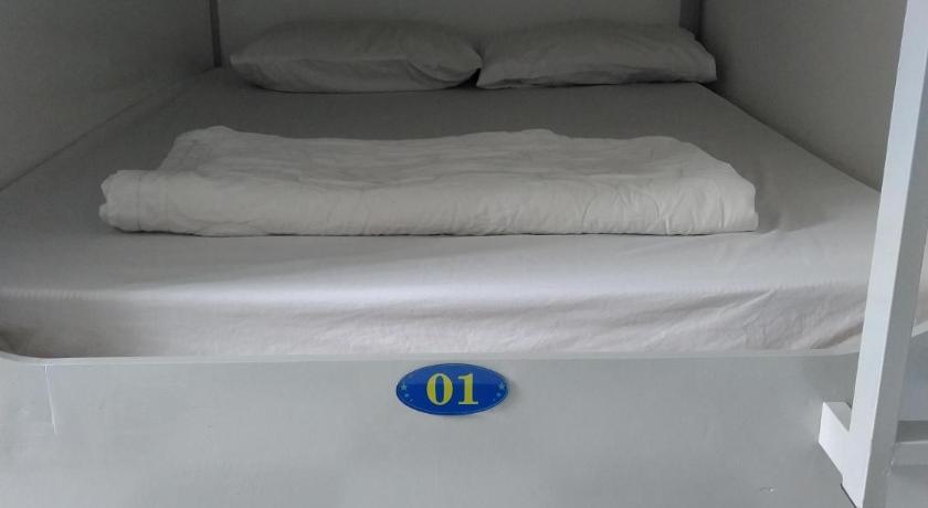 a bed in a room with a white bedspread, Sao Mai 896 Hotel in Ho Chi Minh City