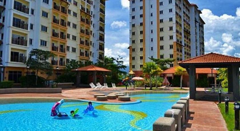 a swimming pool with a pool table and chairs in front of it, STUDIO SURIA APARTMENT in Taiping