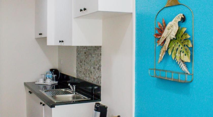 a kitchen with a table and a refrigerator, Sitio Uno Residences in Roxas City (Capiz)