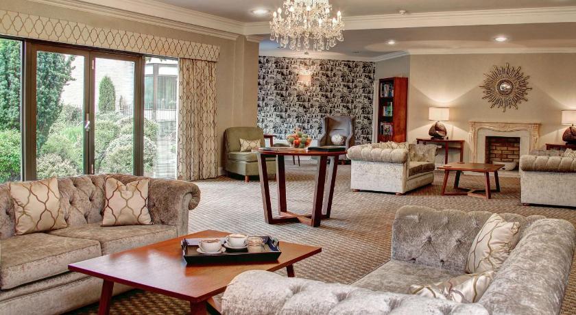 a living room filled with furniture and a fireplace, Best Western Plus Centurion Hotel in Bath
