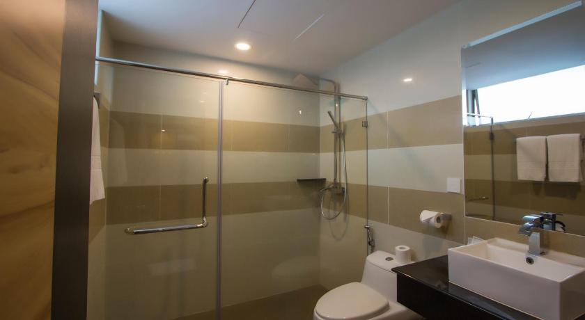 a bathroom with a toilet, sink, and shower, Mariner Hotel Labuan in Labuan